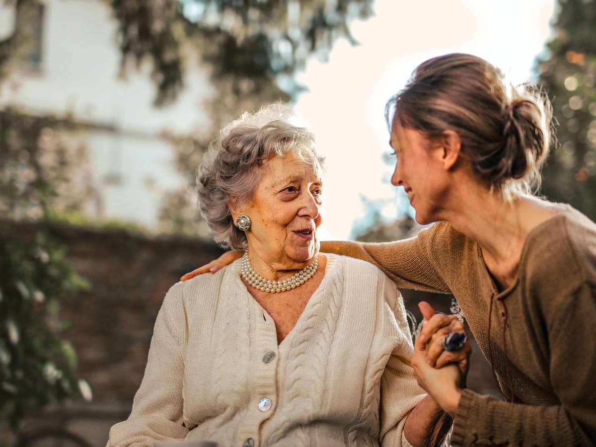 A carer and an older participant talking together